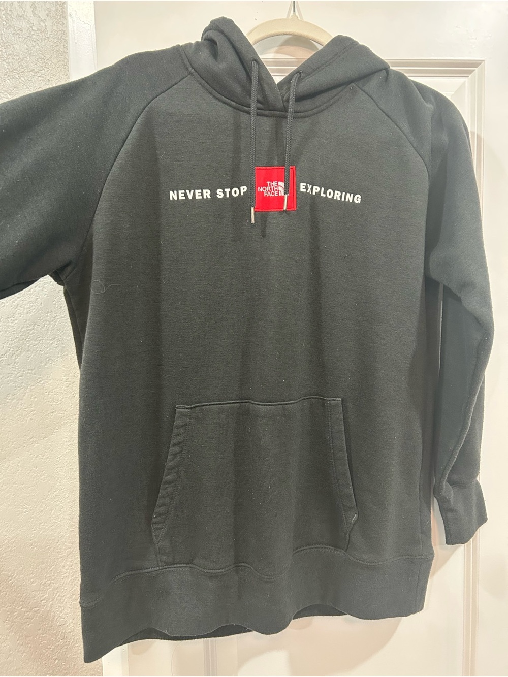 The North Face Black Hoodie with Red Logo Patch